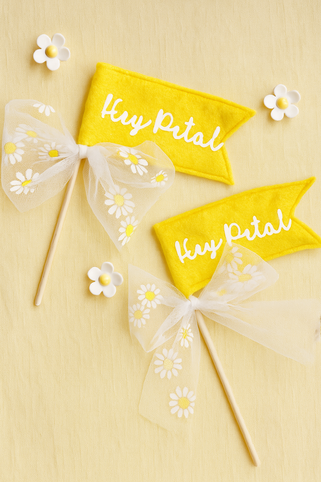 Yellow flags with 'Hey Petal' text and white ribbons on a yellow background
