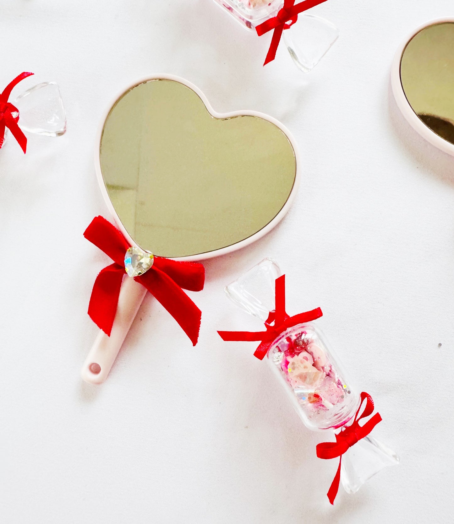 Mini heart shaped red bow hand mirrors