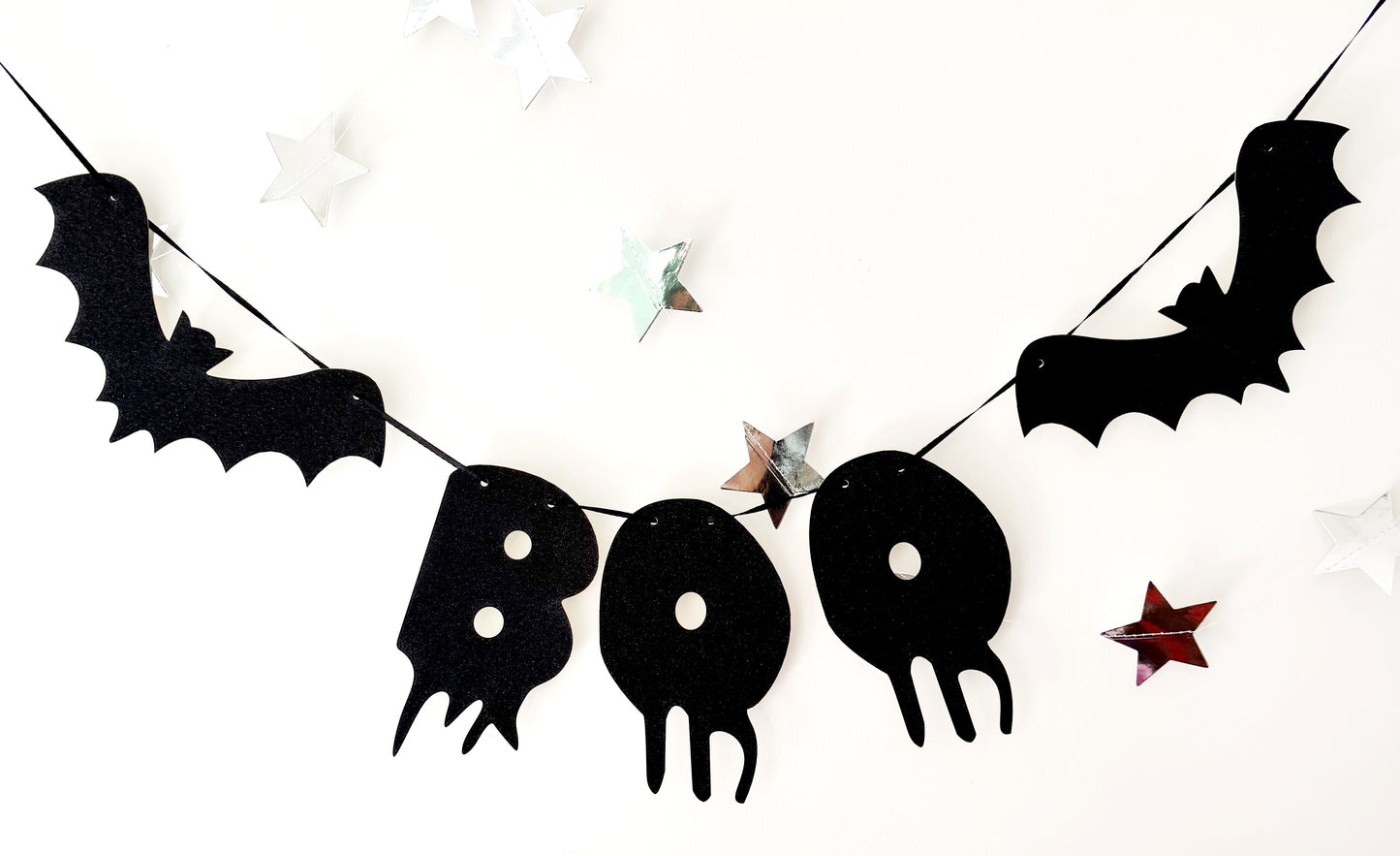 Halloween-themed banner with black bats and 'BOO' letters on a white background
