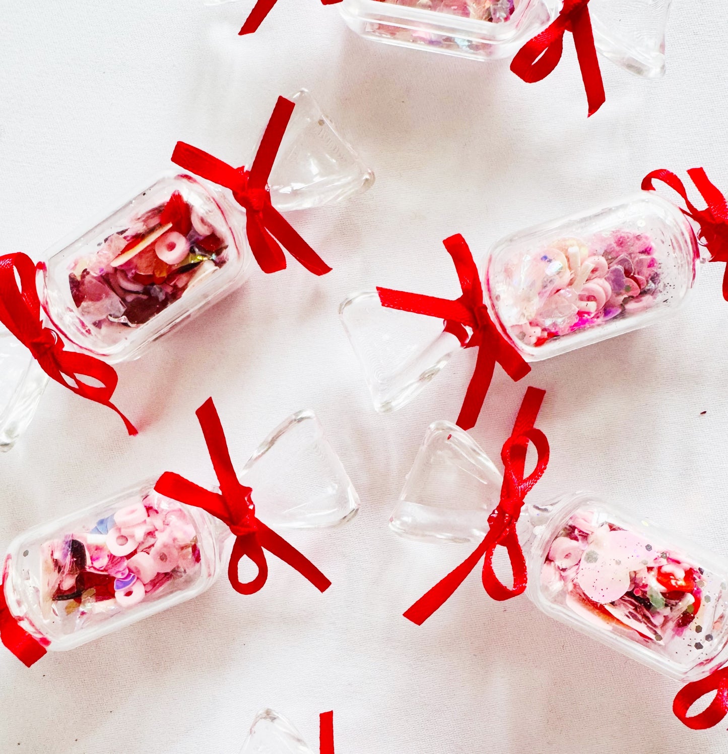 Pink red valentines confetti sprinkles in candy shaped pots