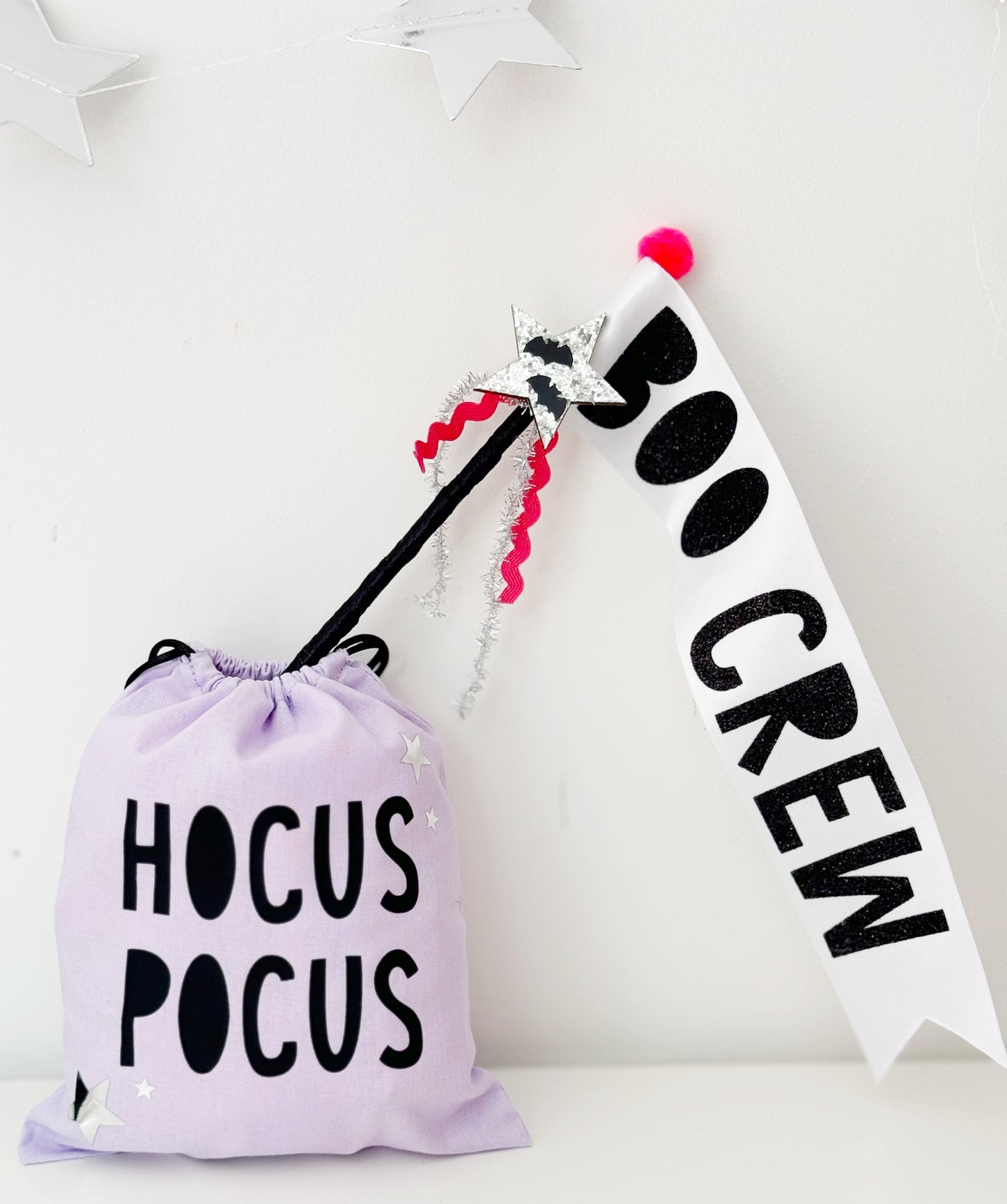 Halloween-themed bag and flag wand with 'Hocus Pocus' and 'Boo Crew' text on a white background.
