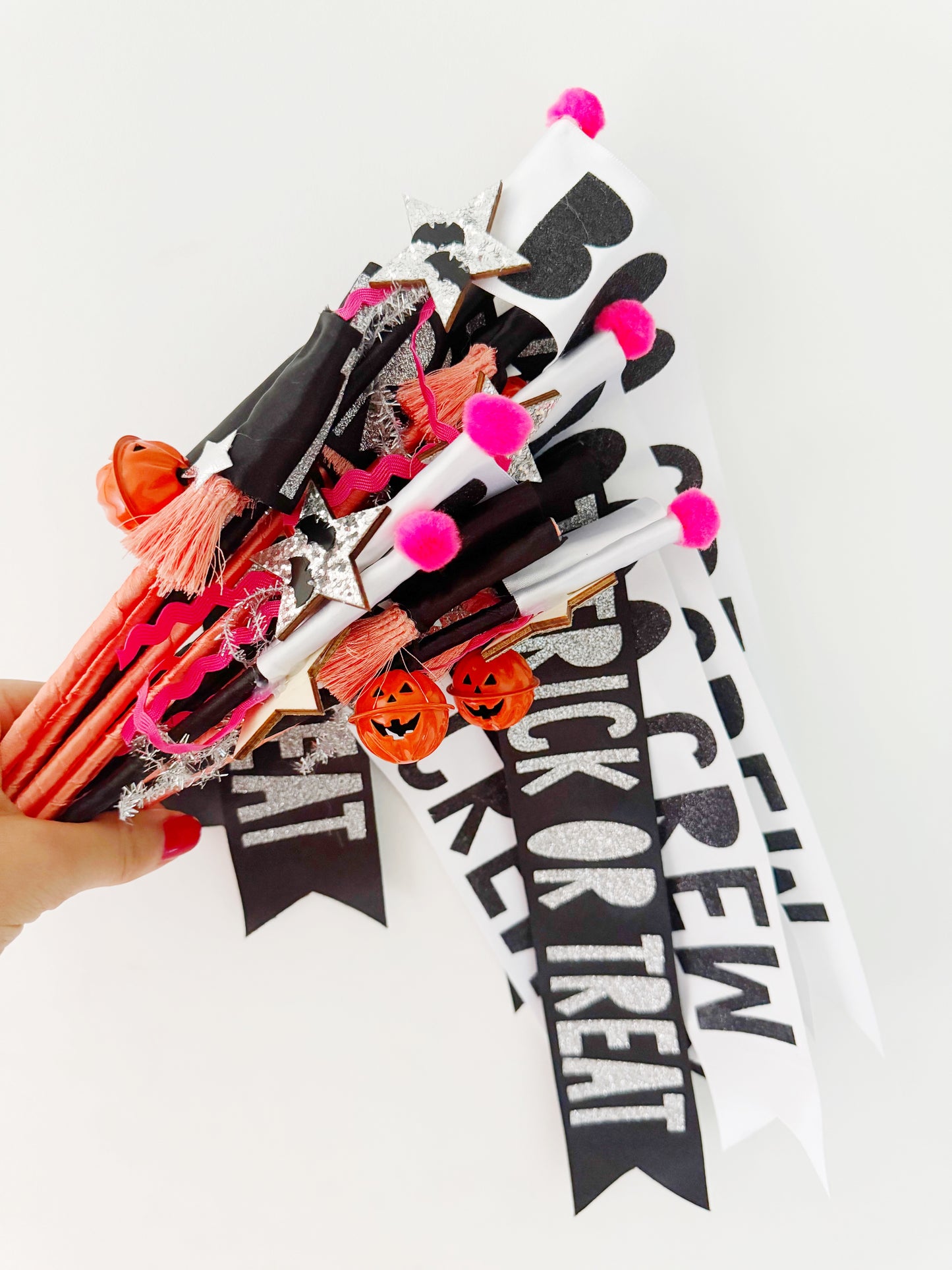 Halloween-themed decorative flag wands with pumpkins and 'Trick or Treat' text on a white background.