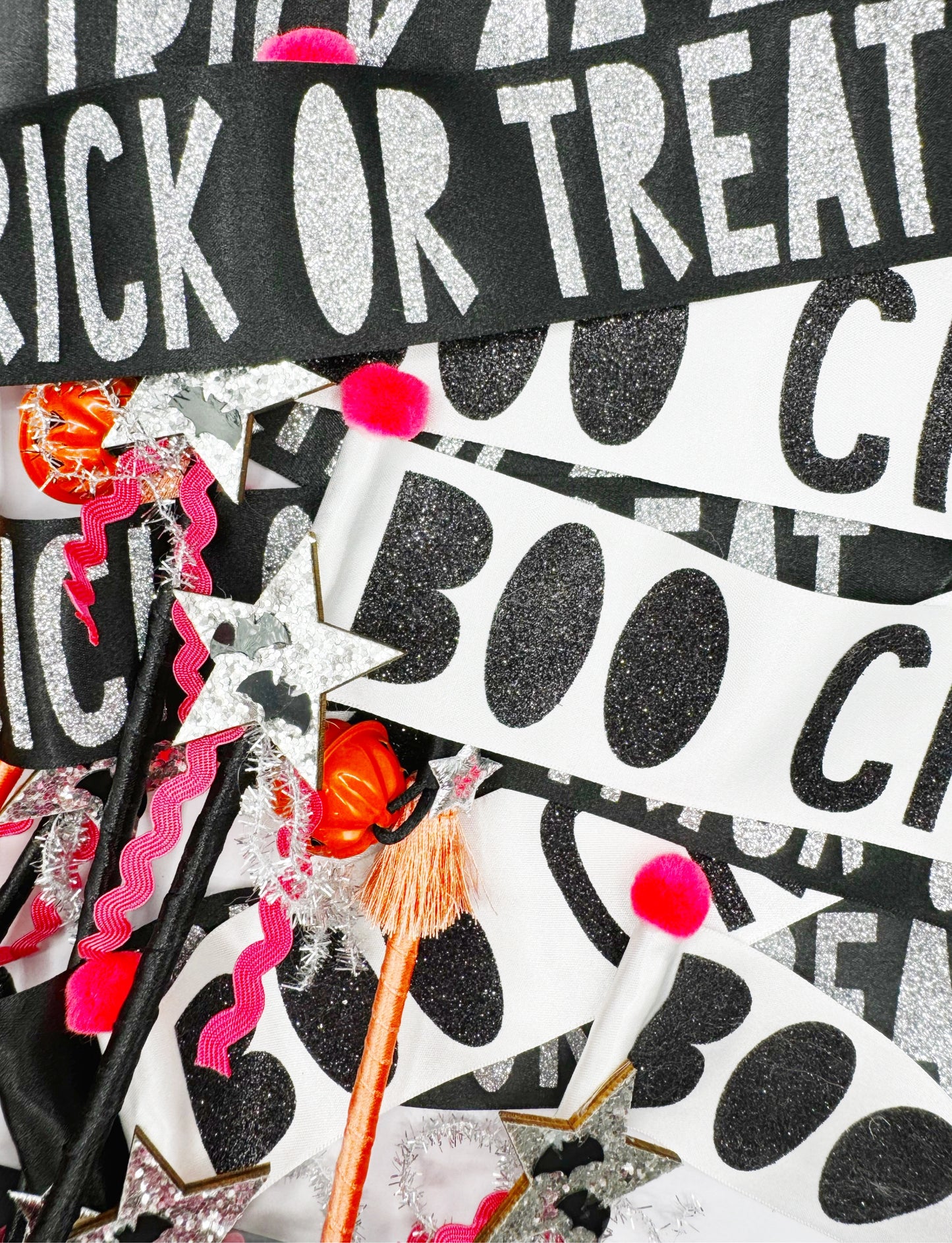 Halloween-themed decorations with 'Trick or Treat' and 'Boo' text, including wands and pom-poms.