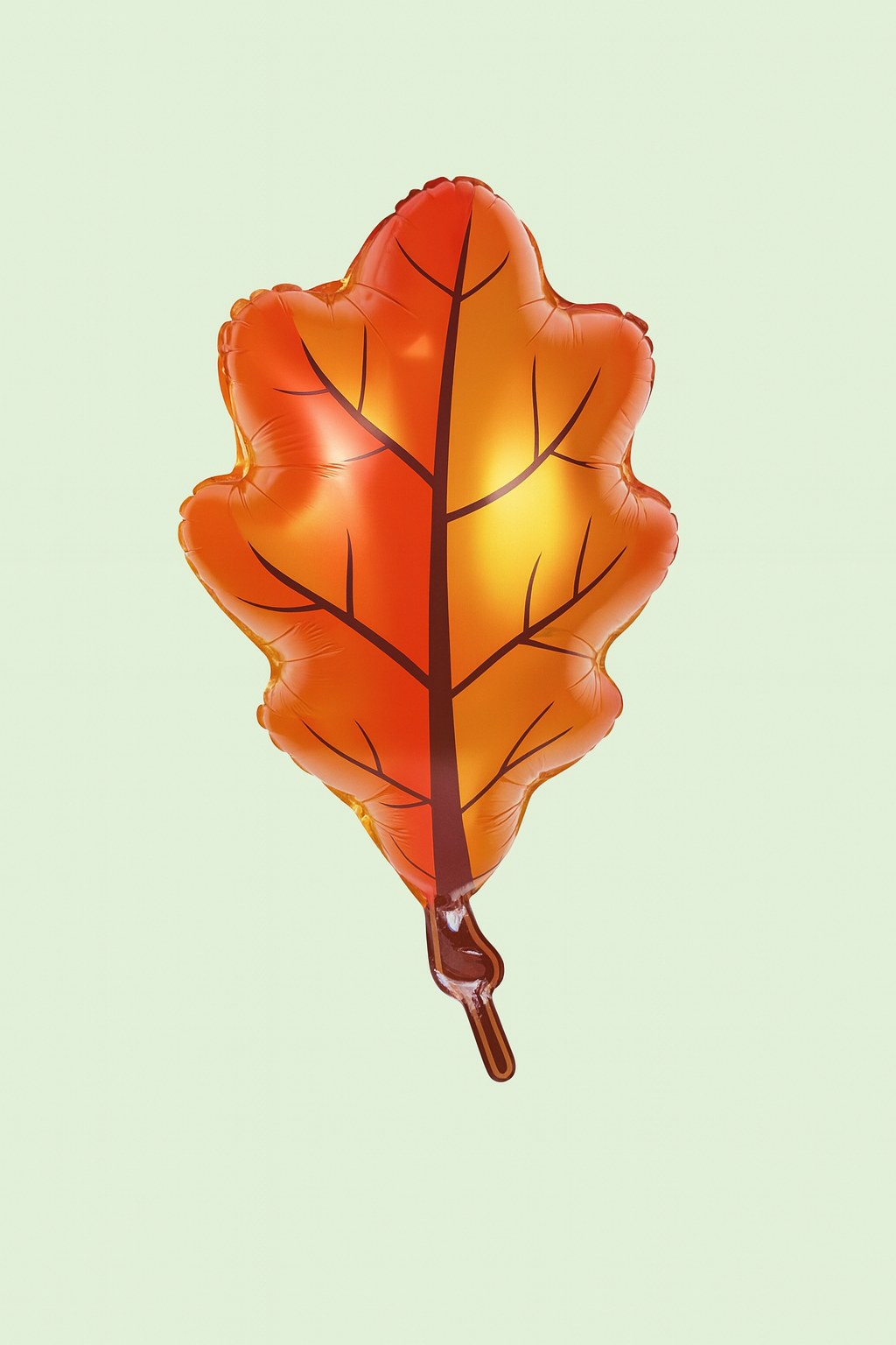 Leaf-shaped balloon with orange and yellow gradient on a light green background