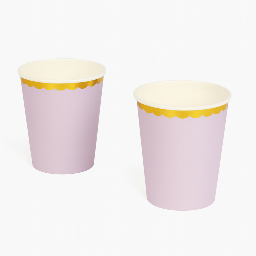 Two purple paper cups with gold rims on a white background