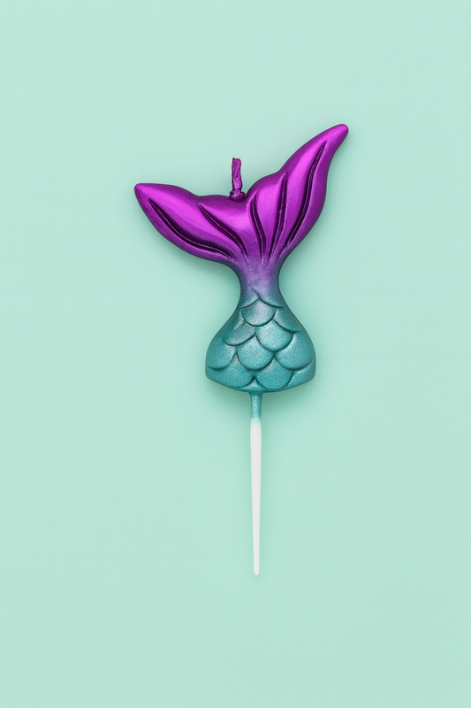 Mermaid tail candle on a stick with purple top and blue bottom against a light green background