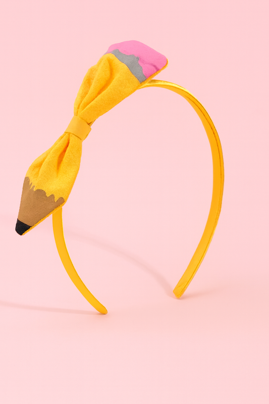 Pencil-shaped headband with a yellow bow on a pink background