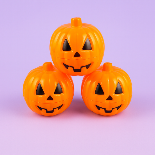 Three orange jack-o'-lantern-shaped containers on a light purple background