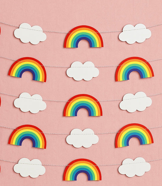 Decorative bunting with rainbow and cloud shapes on a pink background