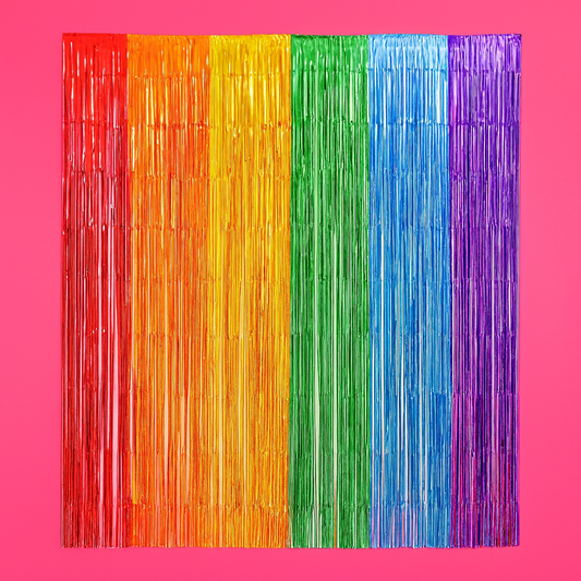 Colorful fringe curtain with red, orange, yellow, green, blue, and purple stripes on a pink background.