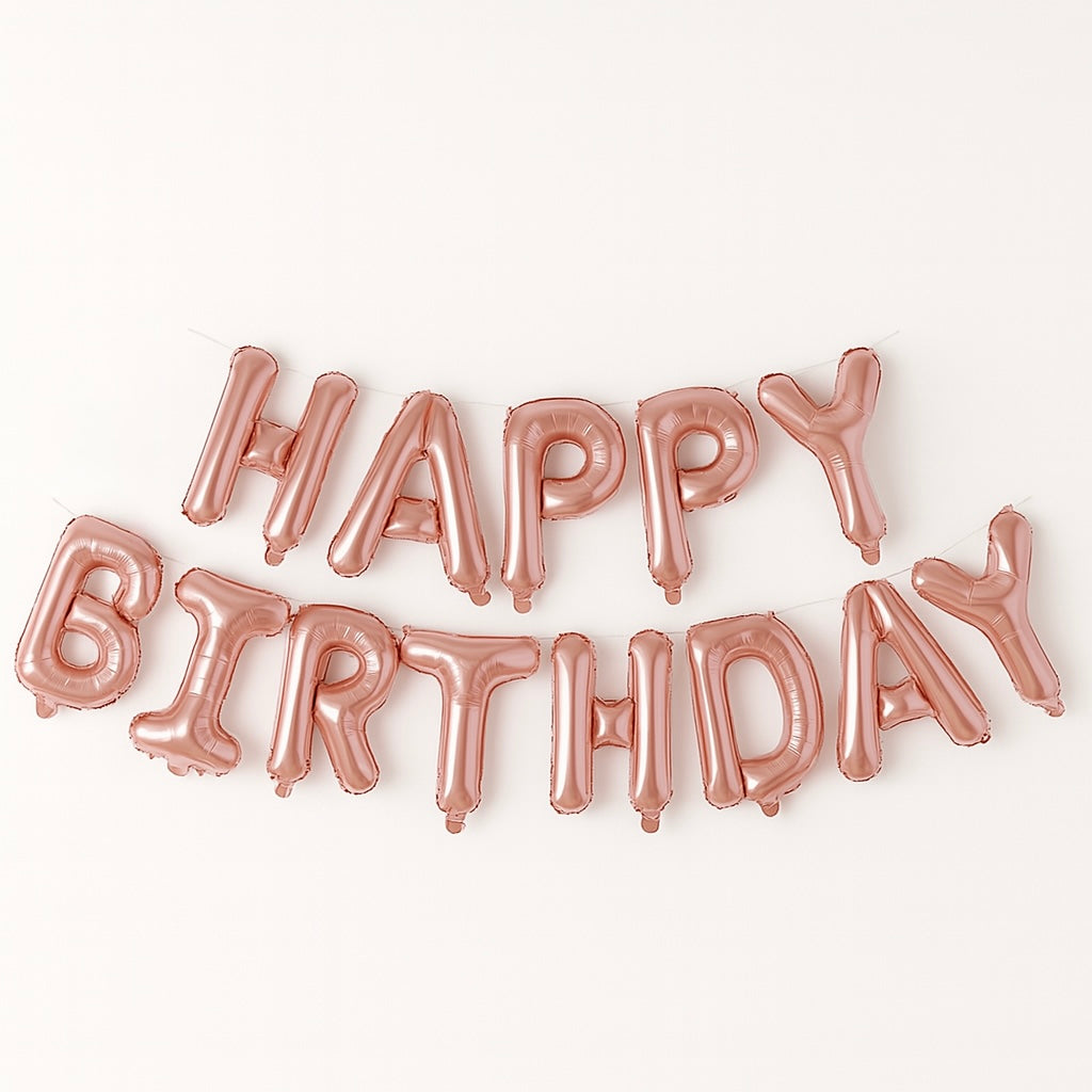 Rose gold 'Happy Birthday' balloon set on a white background