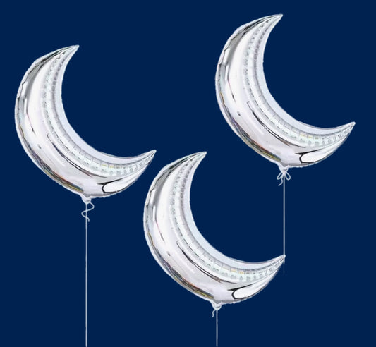Three silver crescent moon balloons against a dark blue background