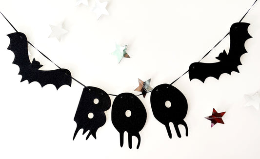 Halloween-themed banner with black bats and 'BOO' letters on a white background