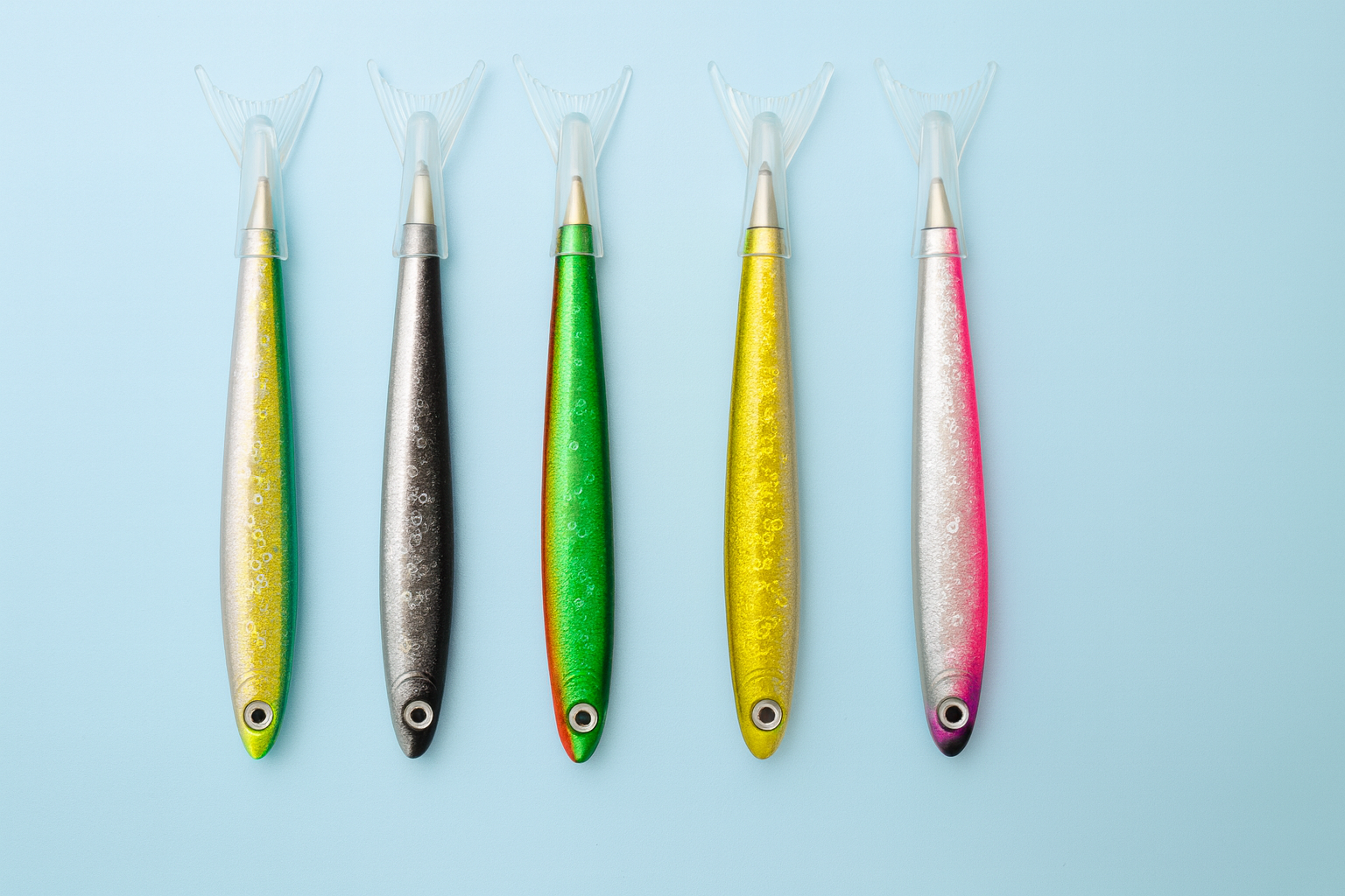 Five colourful fishing pens on a light blue background