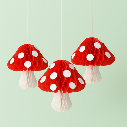 Three red and white polka dot mushroom decorations hanging against a light green background