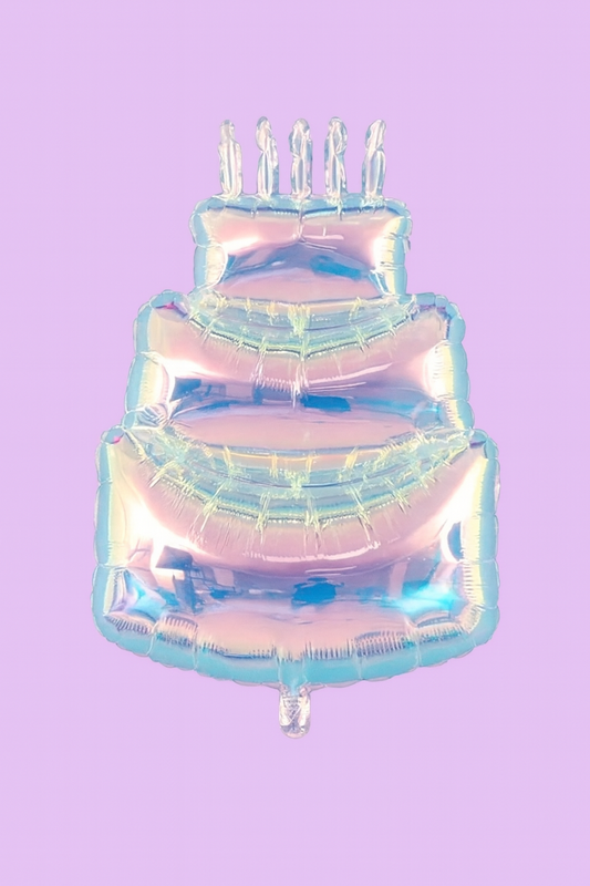 Iridescent birthday cake-shaped balloon with candles on a purple background