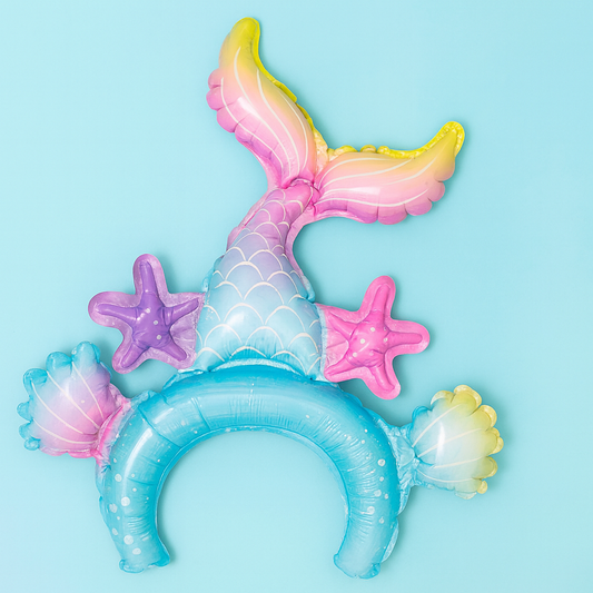 Inflatable mermaid tail with starfish and shells on a blue background