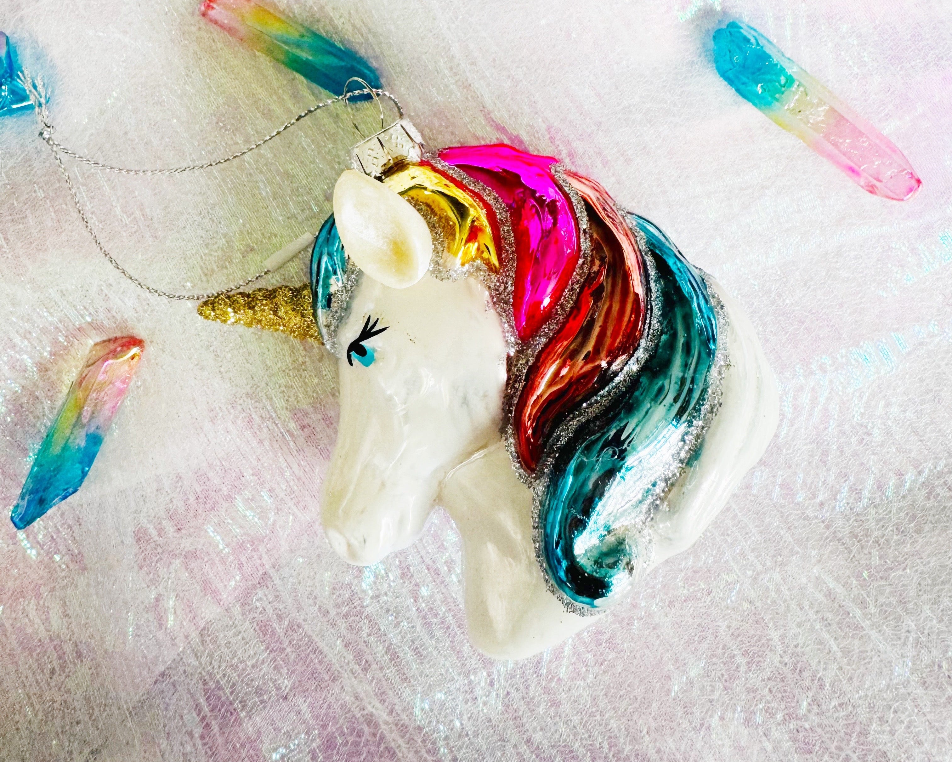 Decorative unicorn party bag fillers with colourful manes on a white background