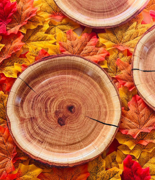 Wood style paper plates on bed of leaves 